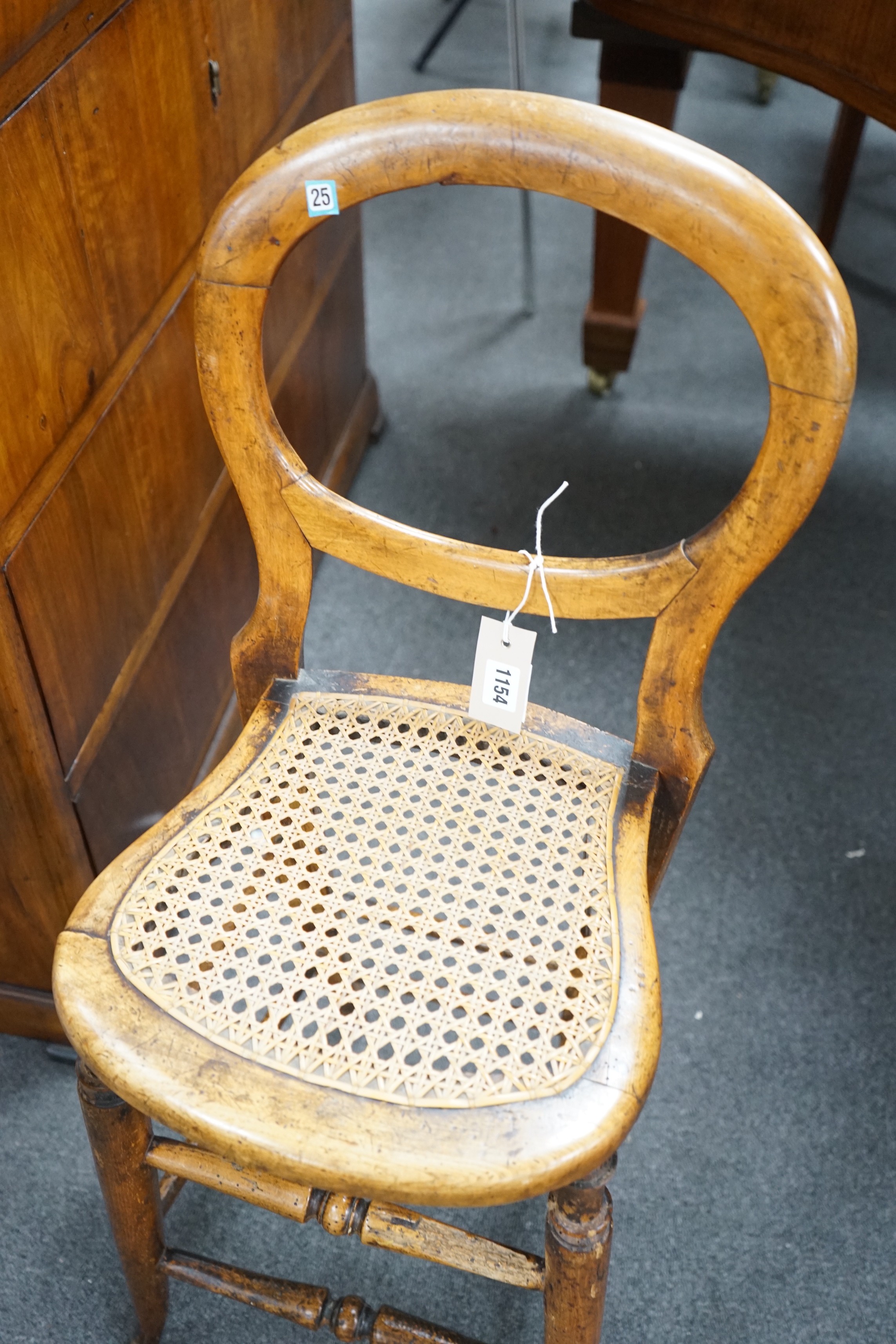 A Victorian caned beech child's correction chair and an Edwardian inlaid mahogany oval occasional table